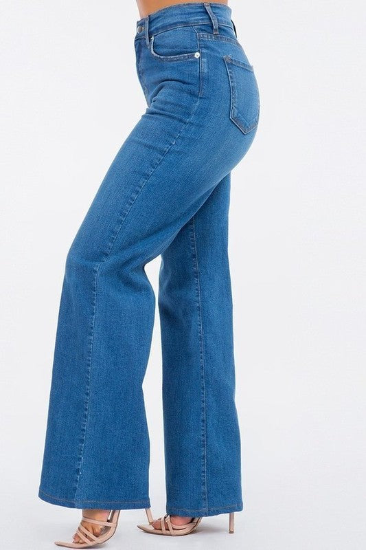 Blue jeans worn by a person on a white background