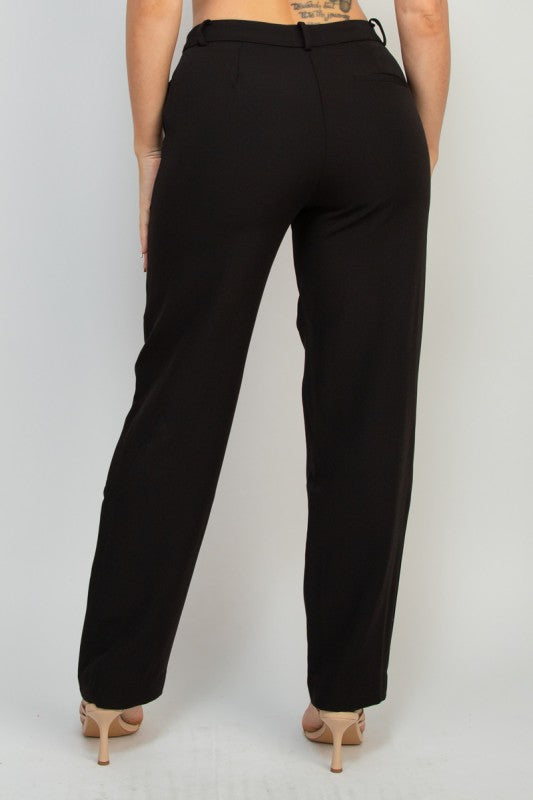 Black pants worn by a woman on a plain background