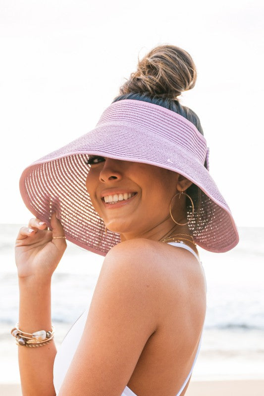 This visor is made of breathable straw with a foldable and portable design, featuring an adjustable velcro closure. It also includes a comfort headband and elastic band for convenient storage. The back has a bow detail and its wide brim provides excellent coverage. One size fits most.