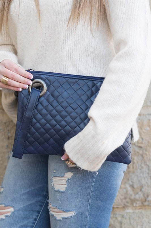 Premium soft quilted PU leather exterior Cotton Herringbone print lining Measures 11.75" x 8.5" Interior Credit Card Deck 2 Open Interior Pockets Attached Wristlet Grommet Detail Color may vary due to lighting on image OneSize: null (Length), null (Width), null (Height)