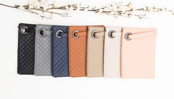 Premium soft quilted PU leather exterior Cotton Herringbone print lining Measures 11.75" x 8.5" Interior Credit Card Deck 2 Open Interior Pockets Attached Wristlet Grommet Detail Color may vary due to lighting on image OneSize: null (Length), null (Width), null (Height)