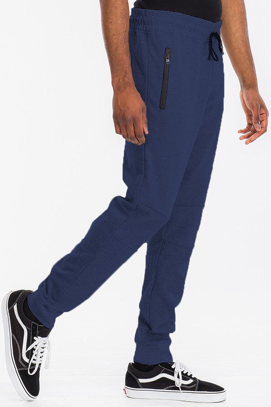 Indulge in comfort with TONY JOGGERS for men. Perfect fit, adjustable drawstring, zippered pocket, and elastic ankle cuff. Designed with a luxurious blend of cotton, polyester, and spandex for comfort and durability.