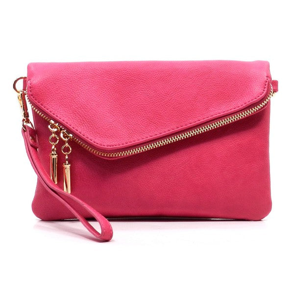 Pink fold-over clutch purse accented with gold tone hardware.