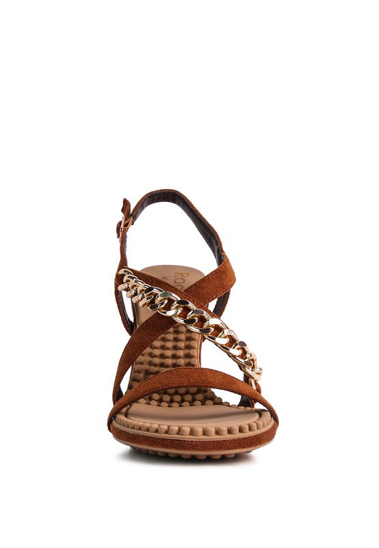 This sandal features a stiletto heel, an open toe, and a microfiber leatherette upper. The lining is made of leatherette, and the outsole is constructed with rubber for added durability. The contemporary design includes a mid heel, groovy insole and outsole, and a pin buckle for easy opening.