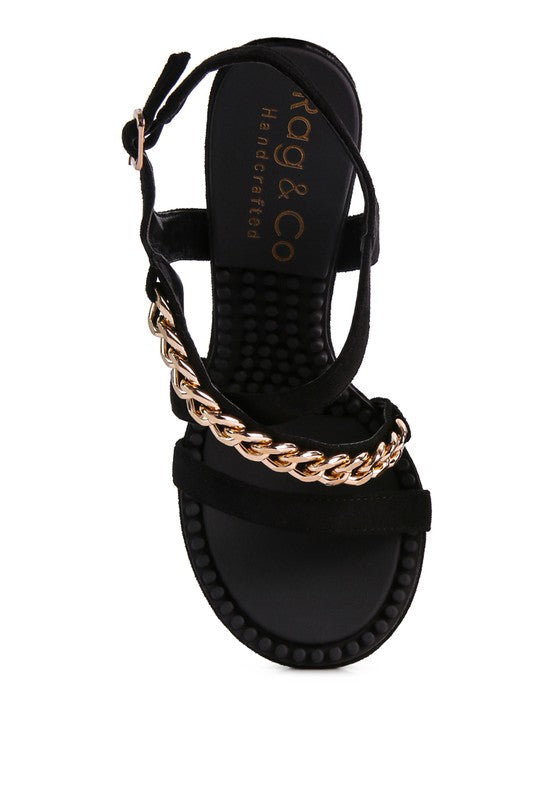 This sandal features a stiletto heel, an open toe, and a microfiber leatherette upper. The lining is made of leatherette, and the outsole is constructed with rubber for added durability. The contemporary design includes a mid heel, groovy insole and outsole, and a pin buckle for easy opening.