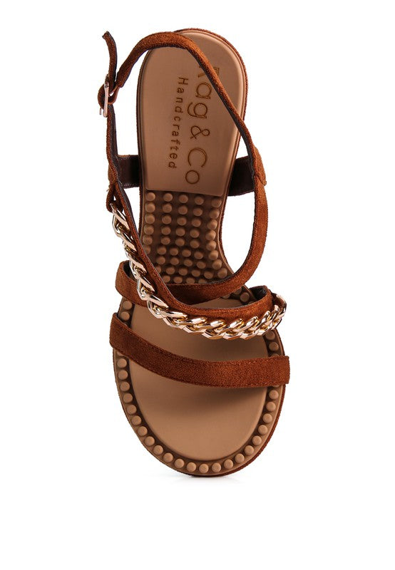 This sandal features a stiletto heel, an open toe, and a microfiber leatherette upper. The lining is made of leatherette, and the outsole is constructed with rubber for added durability. The contemporary design includes a mid heel, groovy insole and outsole, and a pin buckle for easy opening.