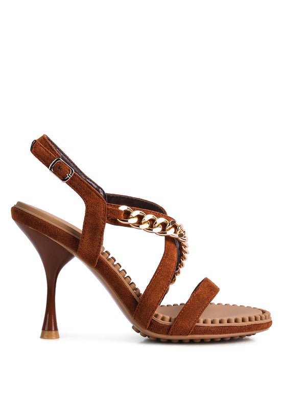 This sandal features a stiletto heel, an open toe, and a microfiber leatherette upper. The lining is made of leatherette, and the outsole is constructed with rubber for added durability. The contemporary design includes a mid heel, groovy insole and outsole, and a pin buckle for easy opening.