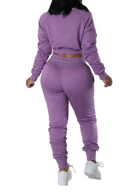 The TOP TWO PIECE PANT SET features a stylish design with long sleeves and an elasticized waist. The top has a bust measurement of 37 inches and a length of 16 inches, while the pants have a length of 43 inches and a waist measurement of 25 inches with a hip measurement of 37 inches. Made with 95% polyester and 5% spandex, it offers both comfort and style.