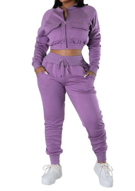 The TOP TWO PIECE PANT SET features a stylish design with long sleeves and an elasticized waist. The top has a bust measurement of 37 inches and a length of 16 inches, while the pants have a length of 43 inches and a waist measurement of 25 inches with a hip measurement of 37 inches. Made with 95% polyester and 5% spandex, it offers both comfort and style.