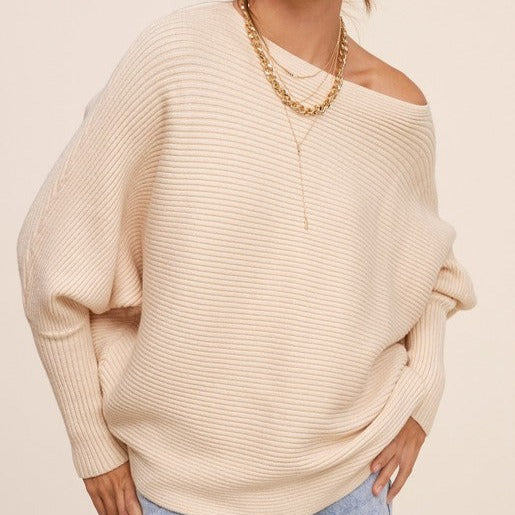 This versatile sweater is perfect for layering or wearing on its own. It is a must-have addition to any sweater collection, made with a ribbed knit fabric and featuring a boat neckline and slouchy bubble sleeves. For a comfortable yet stunning look, it can also be worn off the shoulder.