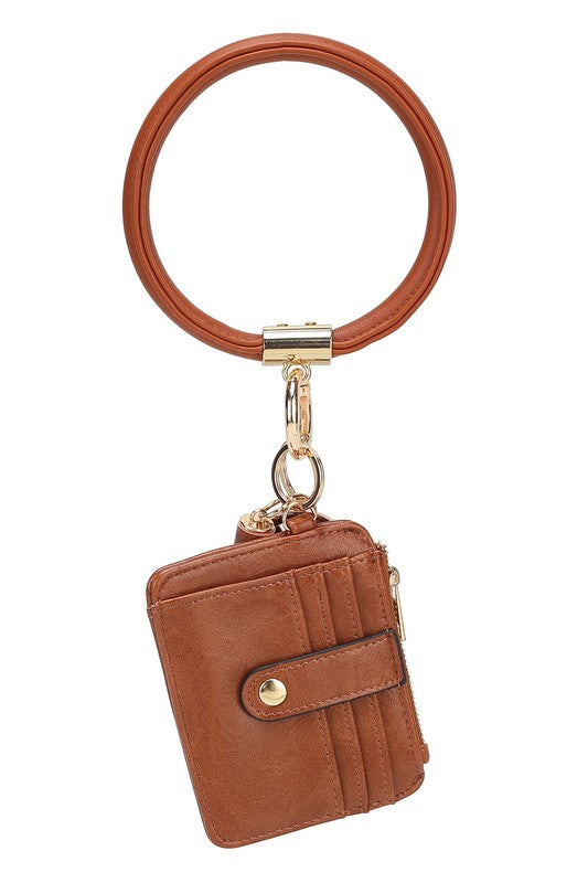 Introducing the MARIE VEGAN LEATHER KEYCHAIN – a stylish and practical accessory that combines a bracelet, credit card holder, and gold-tone hardware. Compact and versatile with a zipper and snap closure, upgrade your keychain game with MARIE!