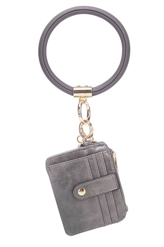 Introducing the MARIE VEGAN LEATHER KEYCHAIN – a stylish and practical accessory that combines a bracelet, credit card holder, and gold-tone hardware. Compact and versatile with a zipper and snap closure, upgrade your keychain game with MARIE!