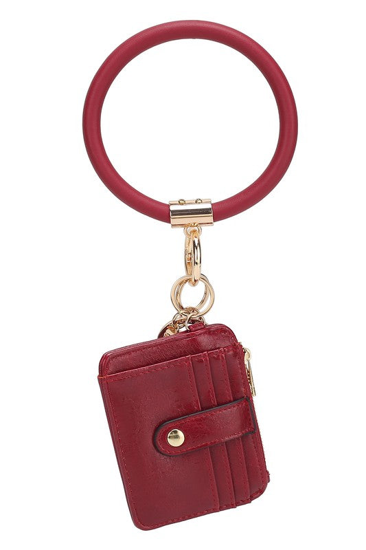 Introducing the MARIE VEGAN LEATHER KEYCHAIN – a stylish and practical accessory that combines a bracelet, credit card holder, and gold-tone hardware. Compact and versatile with a zipper and snap closure, upgrade your keychain game with MARIE!