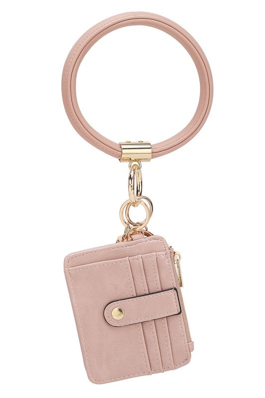 Introducing the MARIE VEGAN LEATHER KEYCHAIN – a stylish and practical accessory that combines a bracelet, credit card holder, and gold-tone hardware. Compact and versatile with a zipper and snap closure, upgrade your keychain game with MARIE!