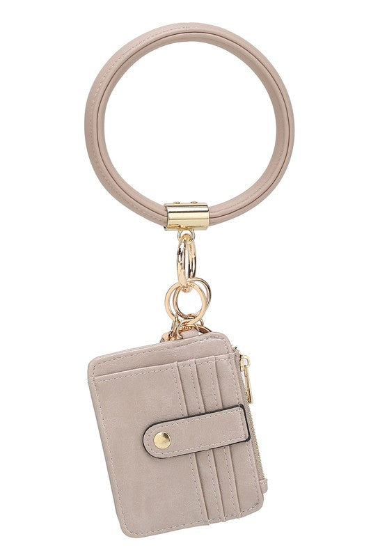 Introducing the MARIE VEGAN LEATHER KEYCHAIN – a stylish and practical accessory that combines a bracelet, credit card holder, and gold-tone hardware. Compact and versatile with a zipper and snap closure, upgrade your keychain game with MARIE!