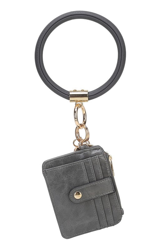 Introducing the MARIE VEGAN LEATHER KEYCHAIN – a stylish and practical accessory that combines a bracelet, credit card holder, and gold-tone hardware. Compact and versatile with a zipper and snap closure, upgrade your keychain game with MARIE!