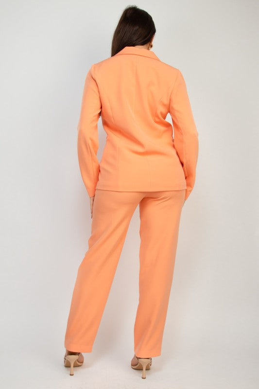 Woman wearing a peach suit on a plain background