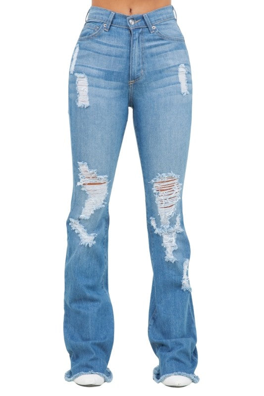 Distressed blue jeans on a white background