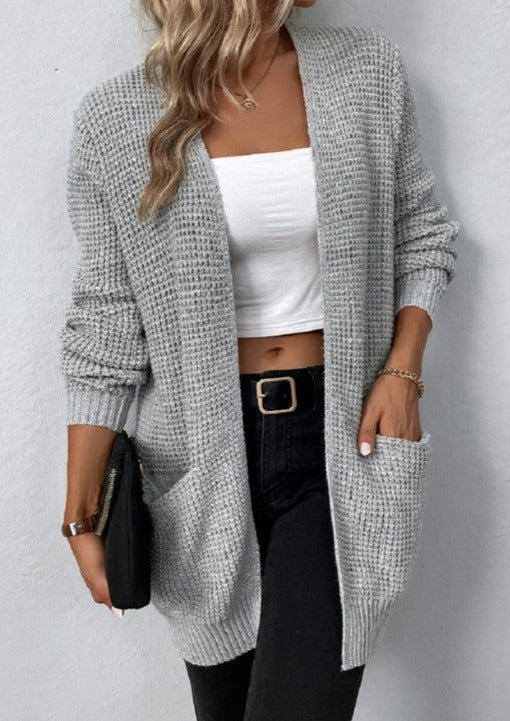 This open front waffle sweater cardigan features a textured waffle knit pattern and long sleeves for a cozy and comfortable fit. It also has two pockets at the front for added convenience. The stretch material ensures a flexible and flattering look, and it is not sheer. Perfect for any occasion, this cardigan will quickly become a staple in your wardrobe.