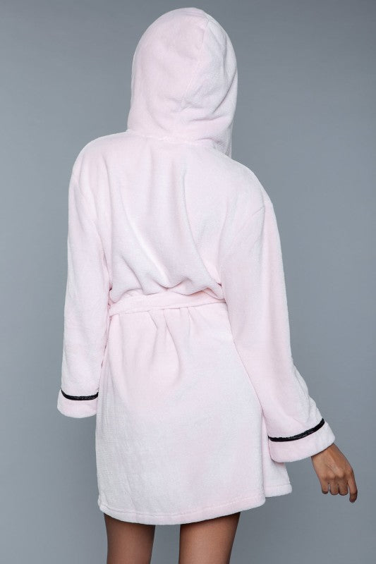 Pink hooded robe with black trim on a gray background