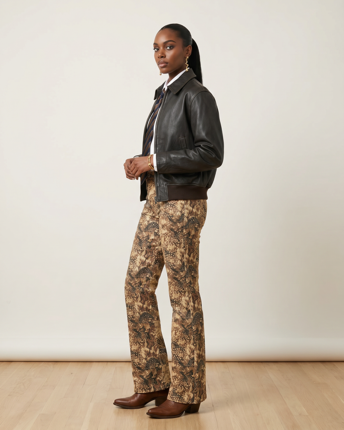 Side view of a model wearing Bambi Cowgirl Wide Leg Jeans featuring a brown and tan western-inspired print with a flattering wide-leg fit.