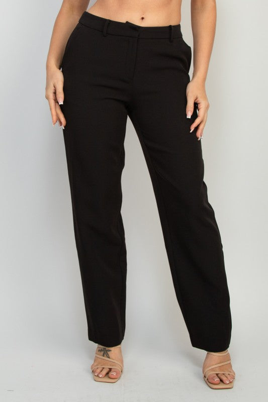 Person wearing black pants on a plain background