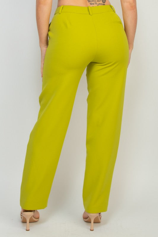 Person wearing bright green pants on a white background