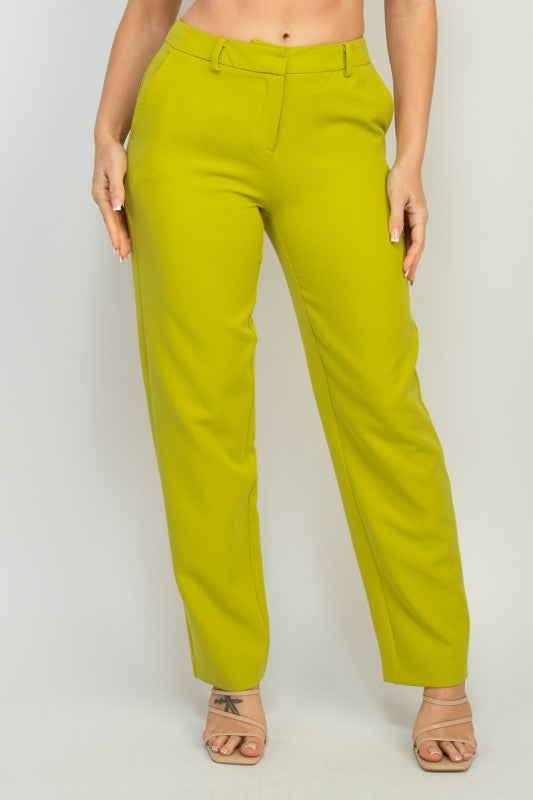 Green pants worn by a person on a white background
