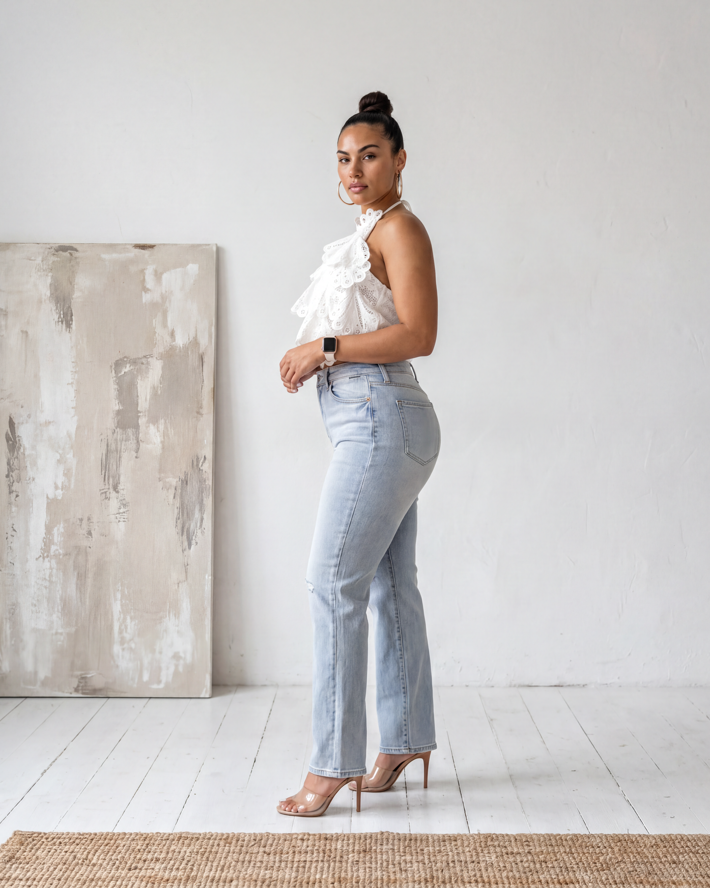 Side profile view of the Madison Distressed Straight Denim Jean in a light wash featuring distressed knees and a relaxed straight-leg fit.