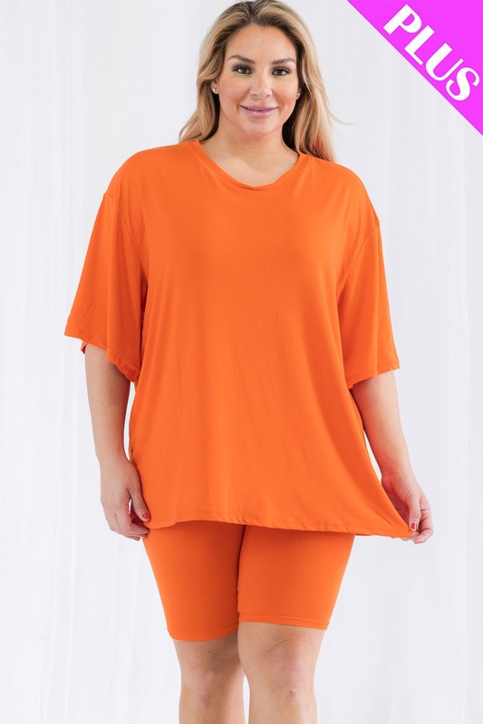 Woman wearing an orange outfit with 'PLUS' text on a white background