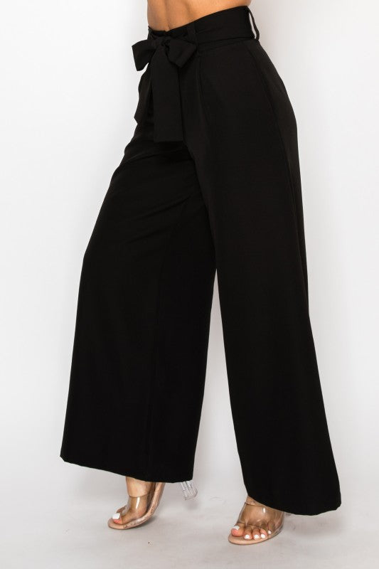 Black wide-leg pants with a tie waist on a white background