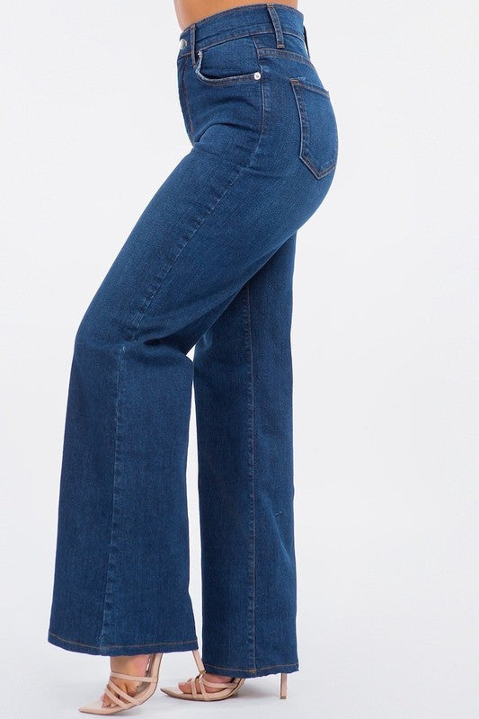Blue jeans being worn on a white background