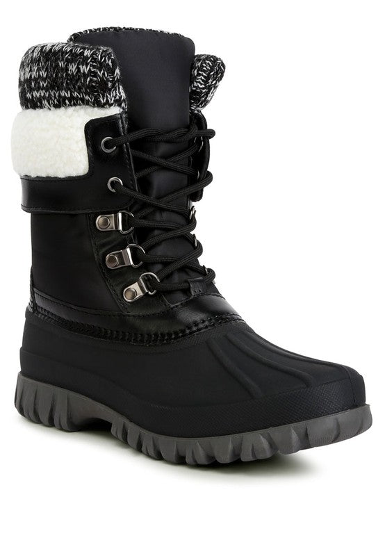 Crafted with a faux leather upper material, these boots feature a TPR outer sole and a closed rounded toe for lasting durability and endless comfort. The lace up closure allows for a secure fit while the knitted collar adds a touch of style. Designed with shearling lining detail and a lug sole, and finished with lightly cushioned insoles, these boots are perfect for any occasion. 