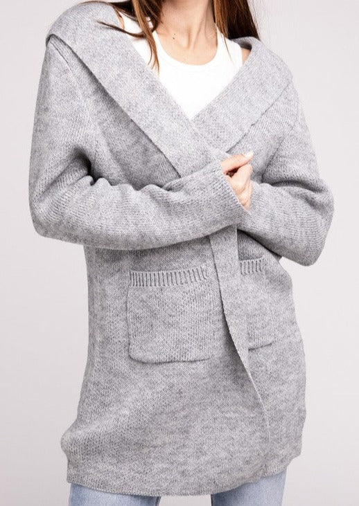 Hooded Open Front Sweater Cardigan, the perfect combination of comfort and fashion. Made with a soft and cozy knit, this cardigan has an open front for easy layering. The attached hood adds casual sophistication, and the front pockets add style and convenience.