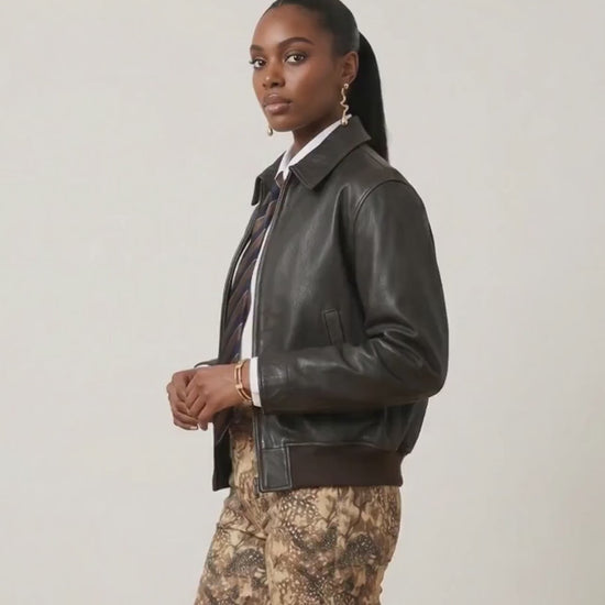 Video of a female model wearing Bambi Cowgirl Wide Leg Jeans featuring a western-inspired brown and tan print, shown from multiple angles to highlight the fit and style.