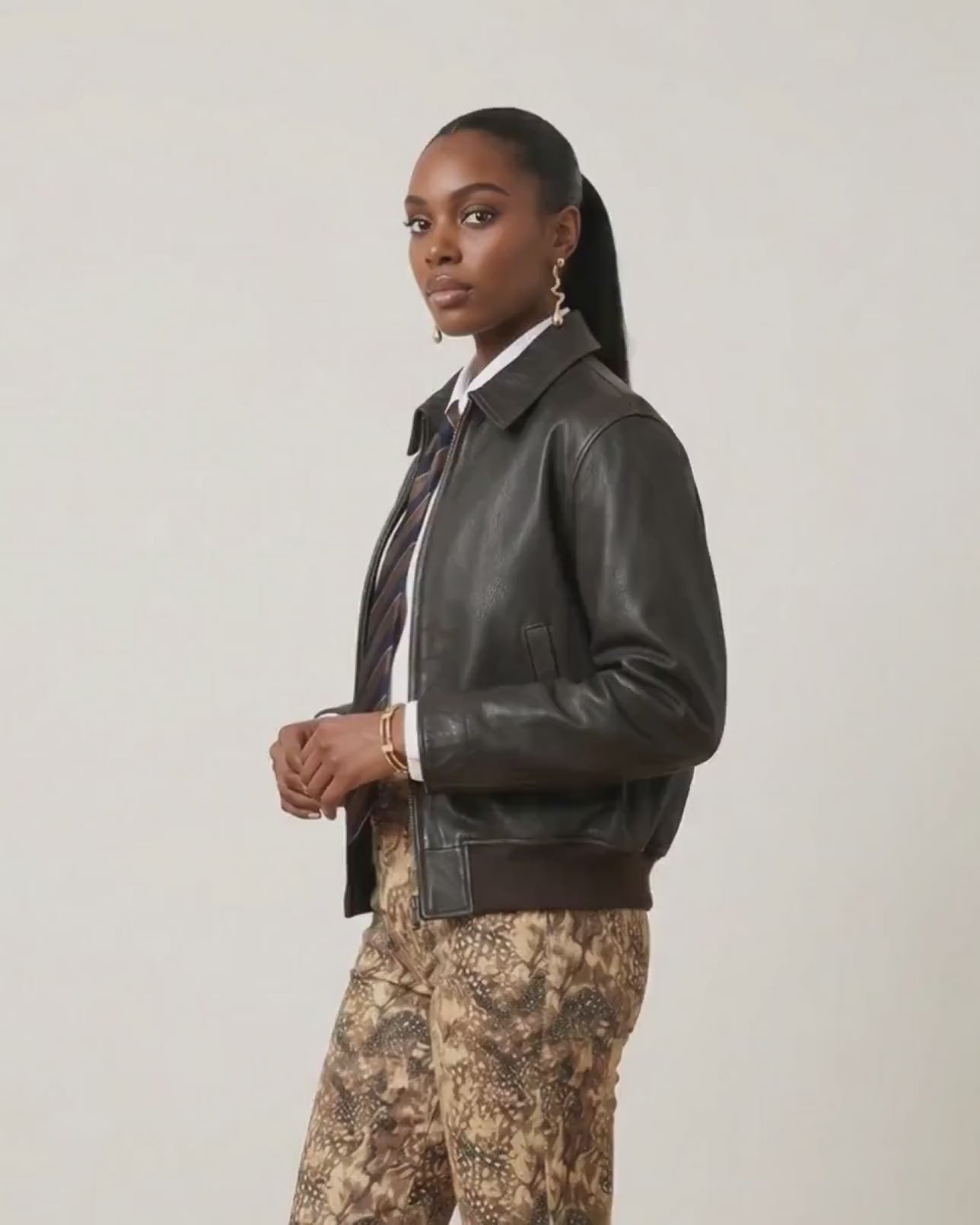 Video of a female model wearing Bambi Cowgirl Wide Leg Jeans featuring a western-inspired brown and tan print, shown from multiple angles to highlight the fit and style.
